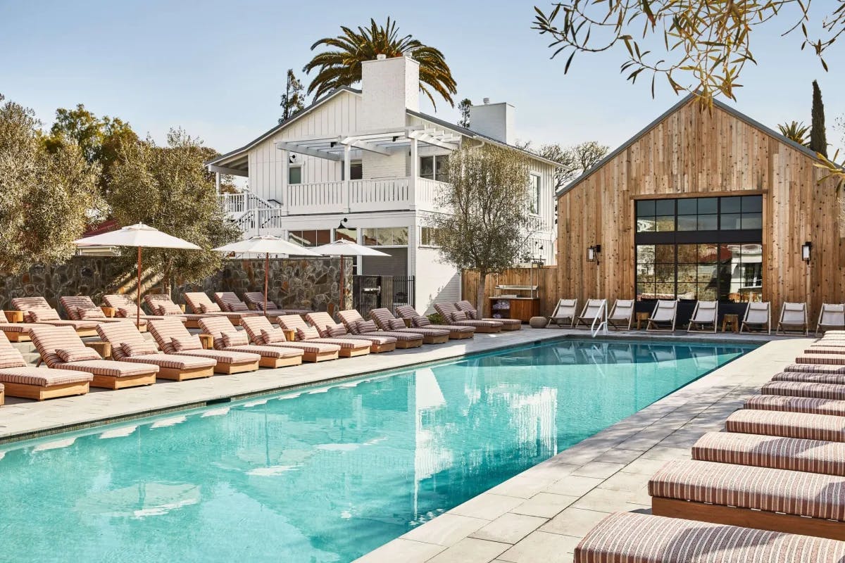 a luxe outdoor pool in a courtyard on a sunny day