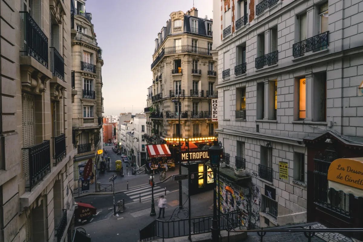 City with buildings and people during early evening. 