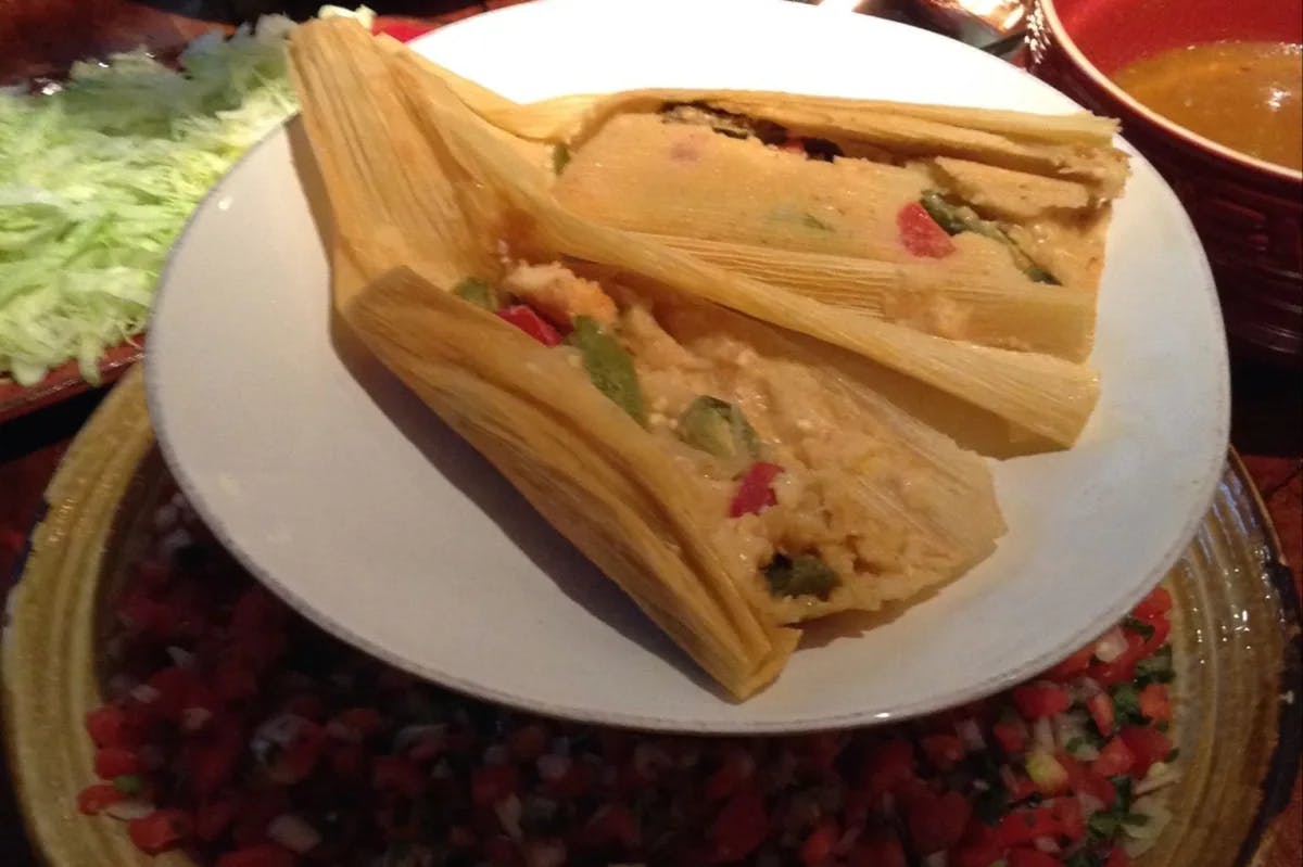 A plate with two tamales 