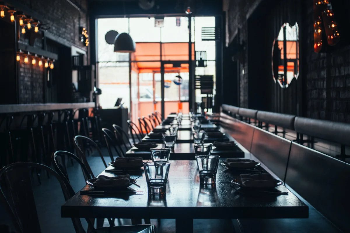 An inside view of the restaurant with table and chairs arranged.