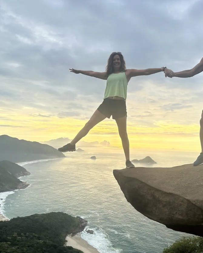 Man and woman standing over the ocean.