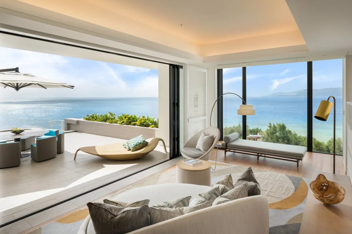 a fancy hotel living room overlooking the ocean