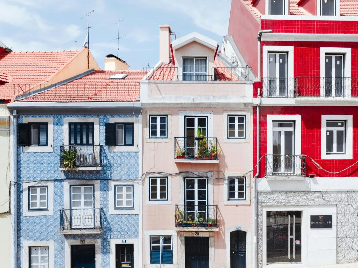 A blue, light pink and red building in Portugal. 