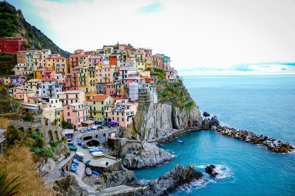 Colorful houses on a cliff near ocean. 