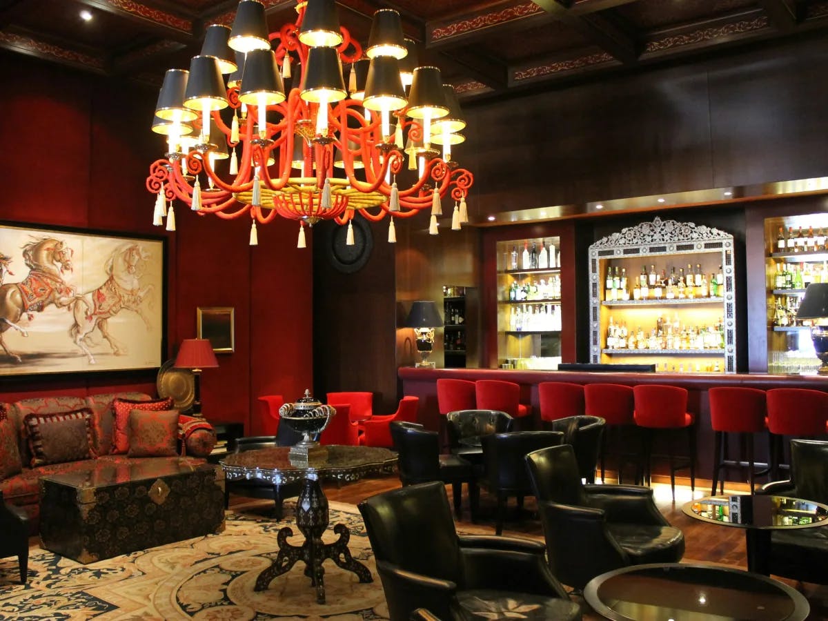 A picture of a vintage interior setting in a restaurant with a bar.