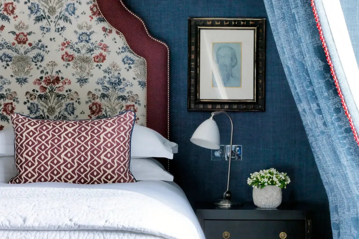 A partial, up close view of the bedding and wall decor in a room at Charlotte Street Hotel in London; the style is detailed and chic, yet whimsical