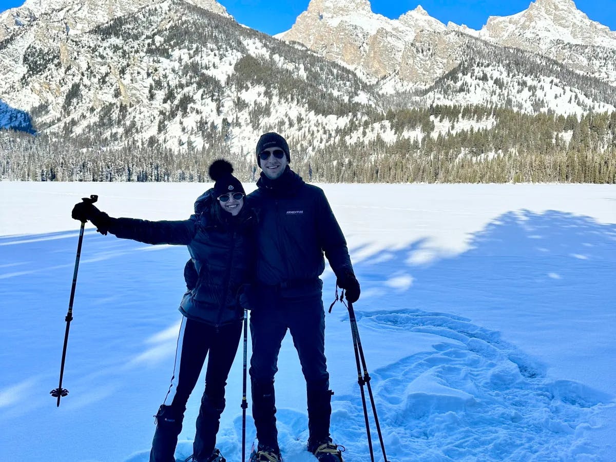 A couple dressed in black snow-gear, taking a break from the slopes, during a ski trip to Jackson Hole.