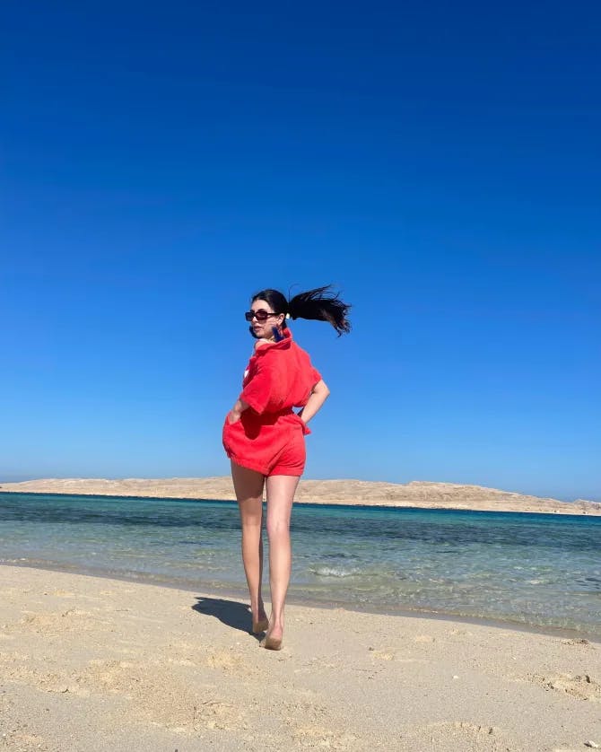 Picture of Gabrielle in red dress at beach