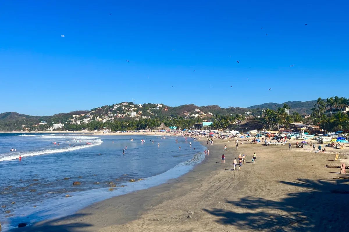 Aerial view of a beach with mountain range in the distance during the daytime