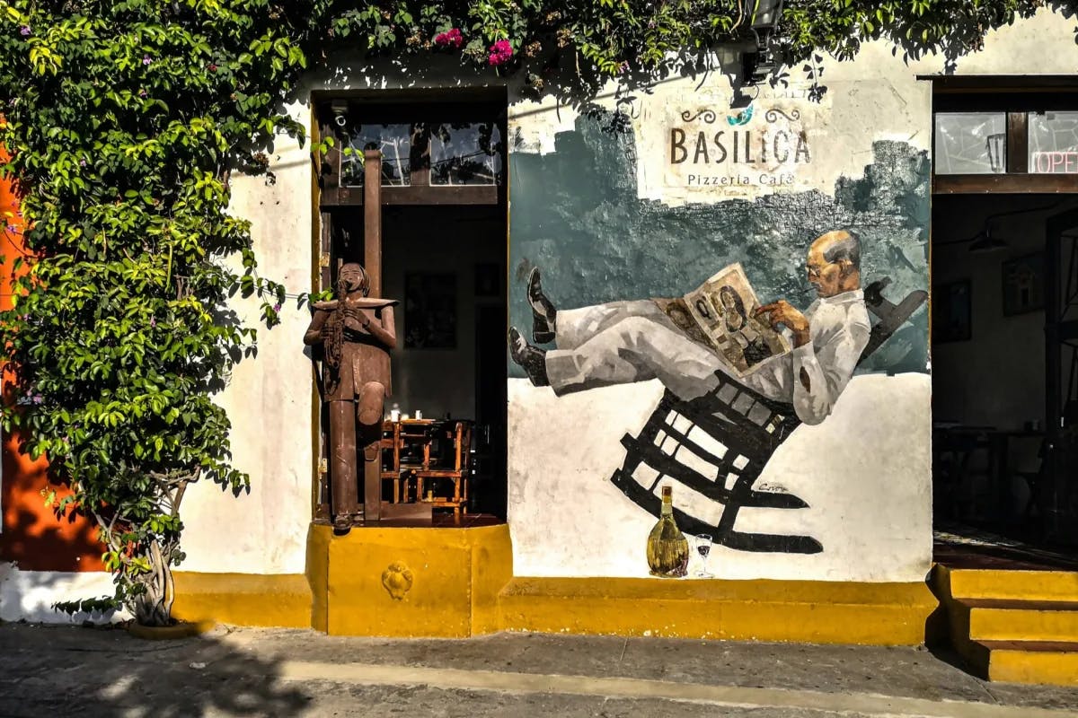 a city street mural of a man reading a newspaper