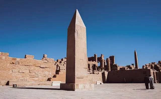 A stone pillar in a courtyard on a clear day