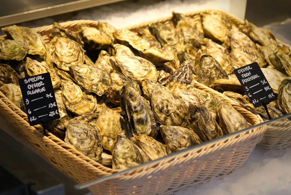 Baskets of fresh oysters for sale at a local Portuguese market.