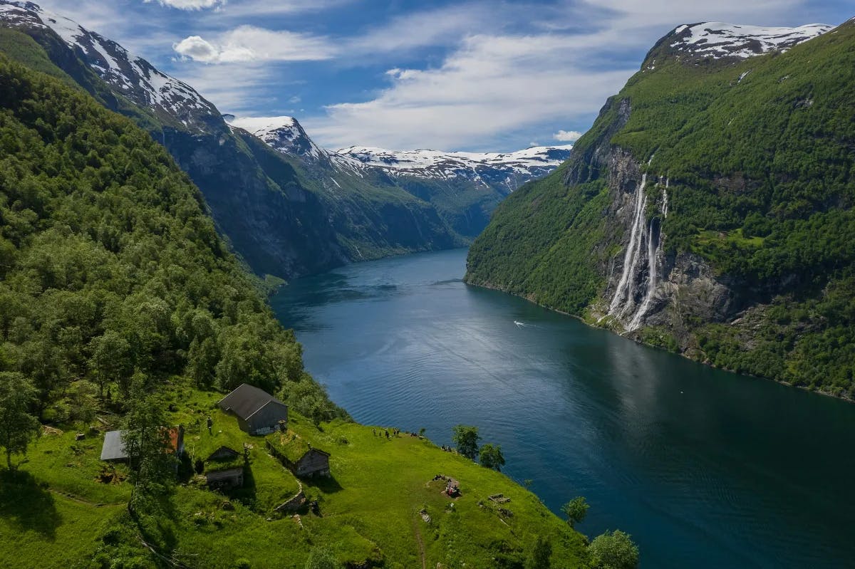 Norway's iconic Geirangerfjord mesmerizes with its cascading waterfalls, steep cliffs, and pristine beauty.