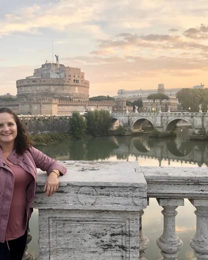 Picture of Katie at Castel Sant'Angelo wearing a purple top at sunset