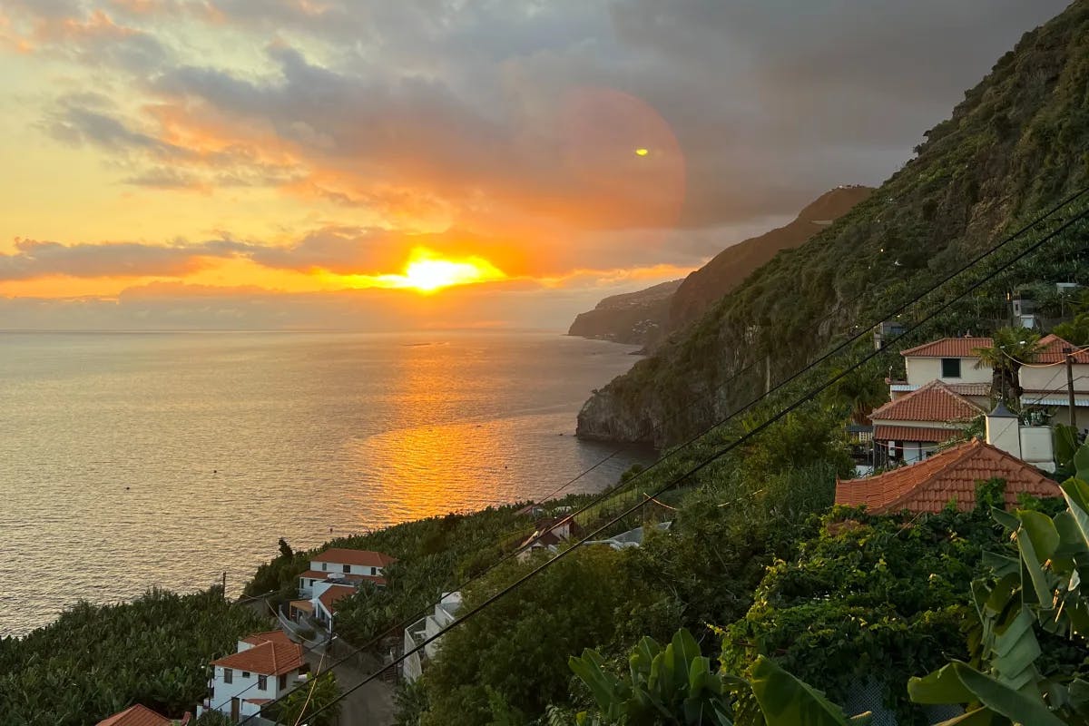 View of buildings on a cliffside by a body of water