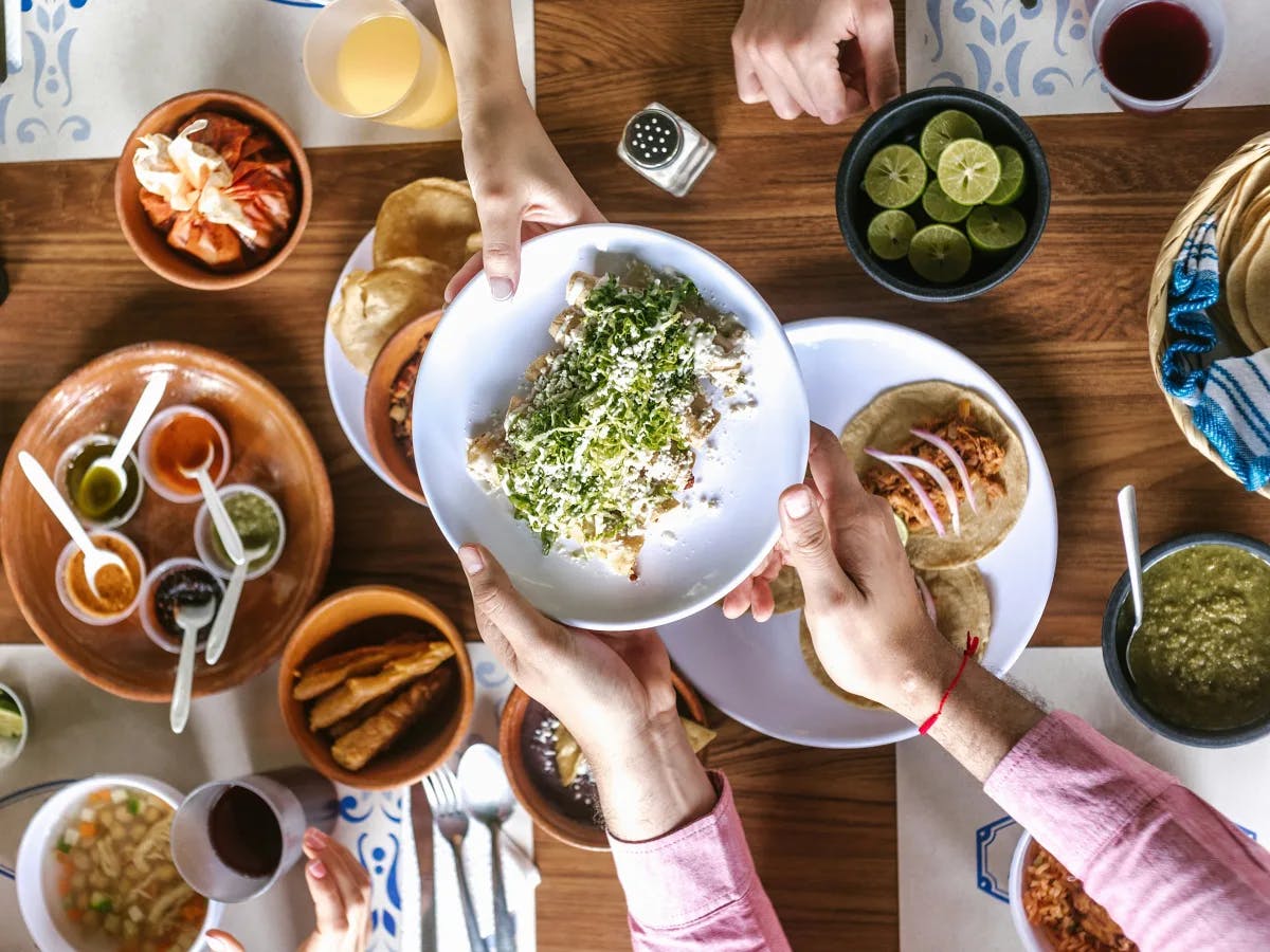 A convivial feast from an aerial perspective, showcasing a tapestry of dishes and the joy of shared meals.