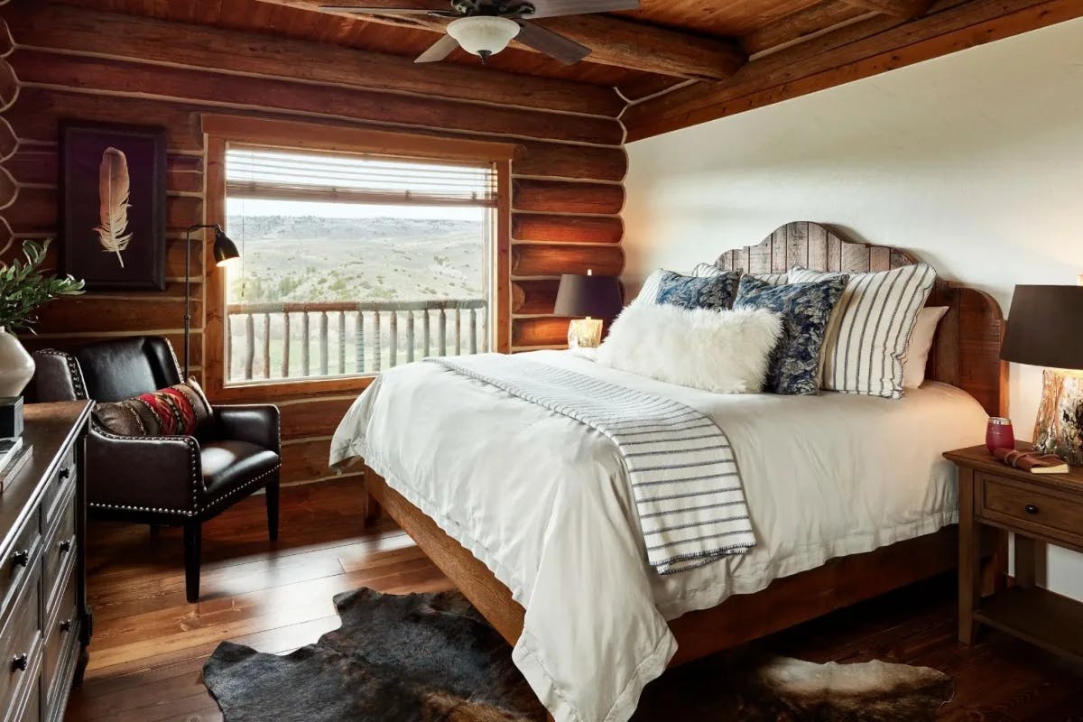 cozy log cabin bedroom with window looking outside