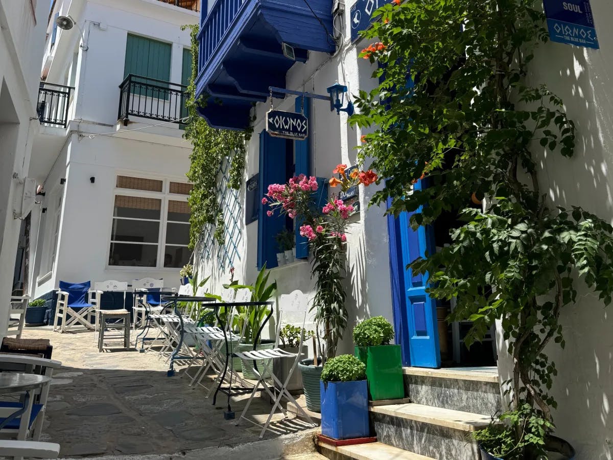 White and blue buildings on a street.