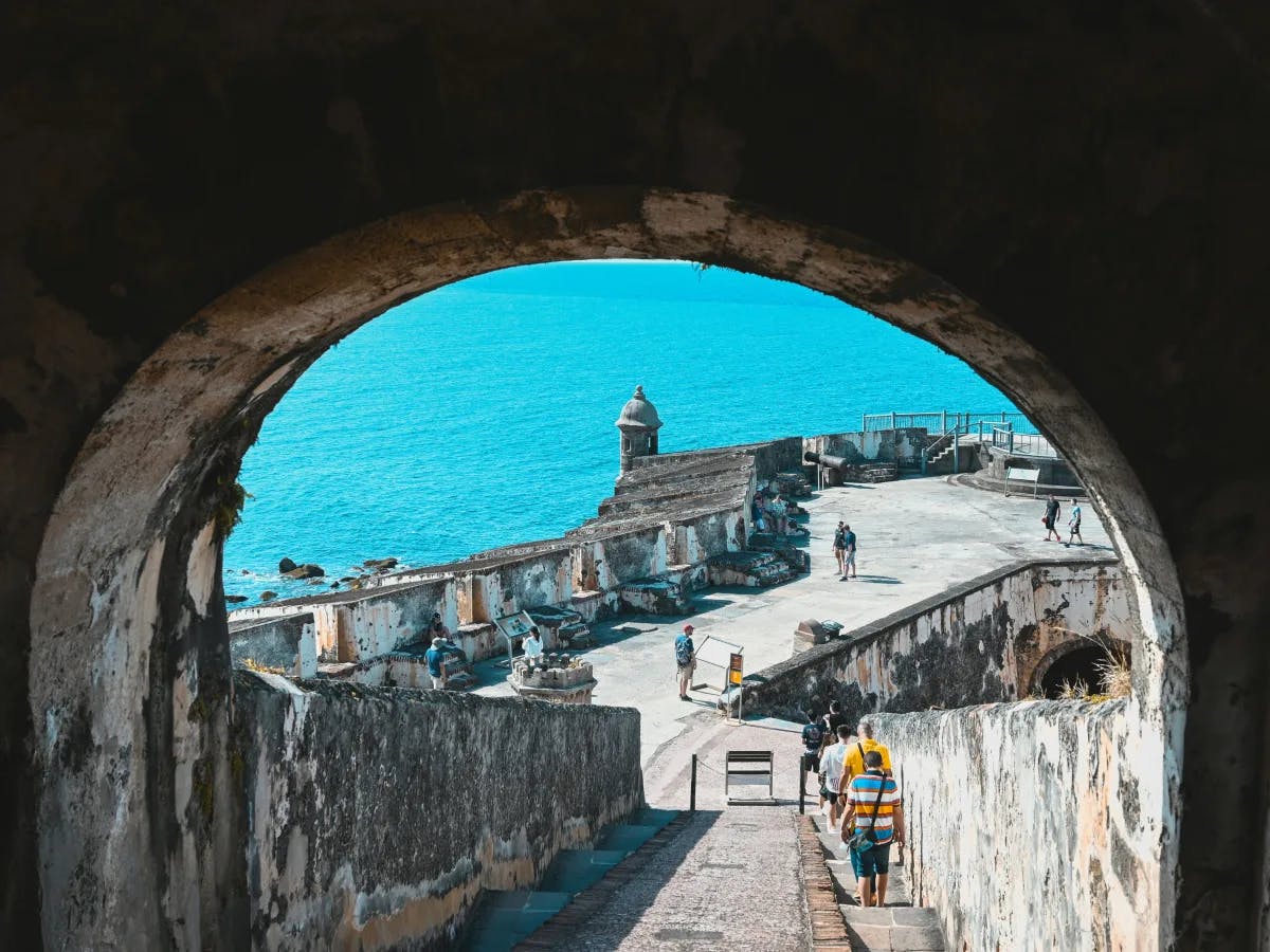 A picture taken from an arch of a coastline near the sea.