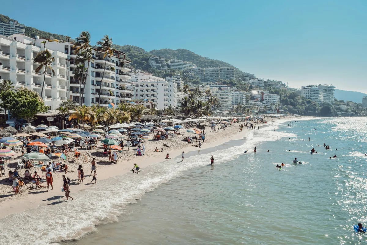 A picture of people on the beach during the daytime.