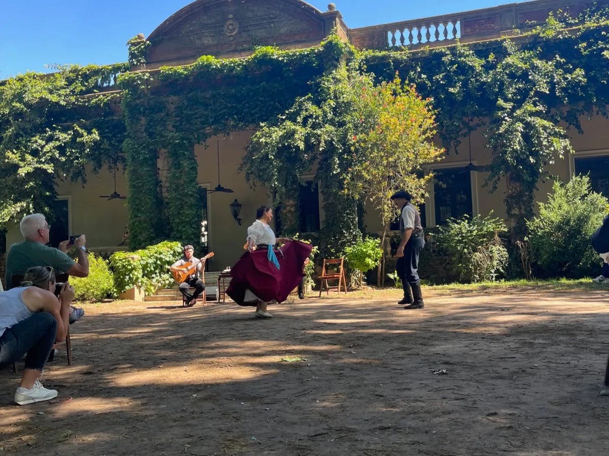 A woman in tradition dress dancing outside. 