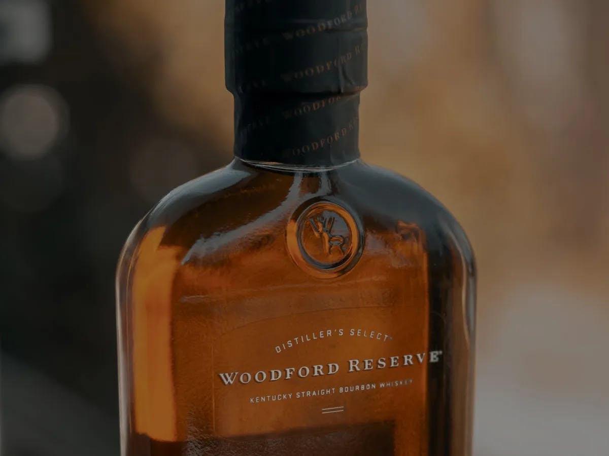 A wine bottle with label Woodford Reserve.