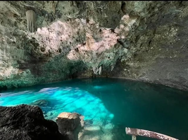 Inside tres Ojos - a luminescent pool of water inside of a cave