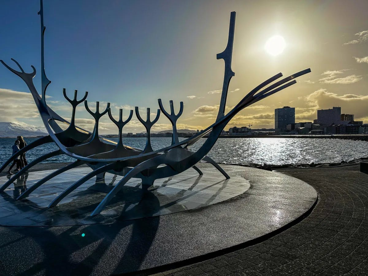 The Solfar sculpture, a large metal installation that looks like a row boat on the edge of water with a city skyline in the background.