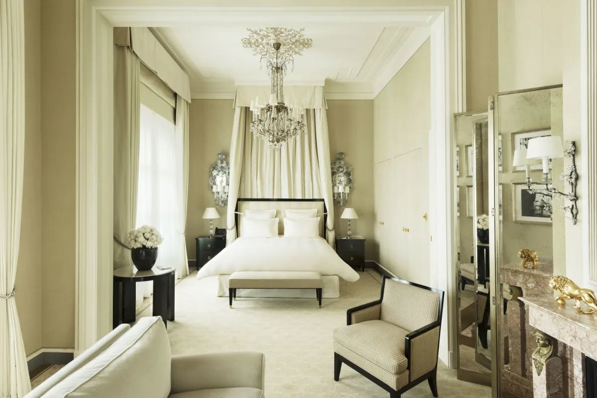 a luxe white bedroom with a canopied bed