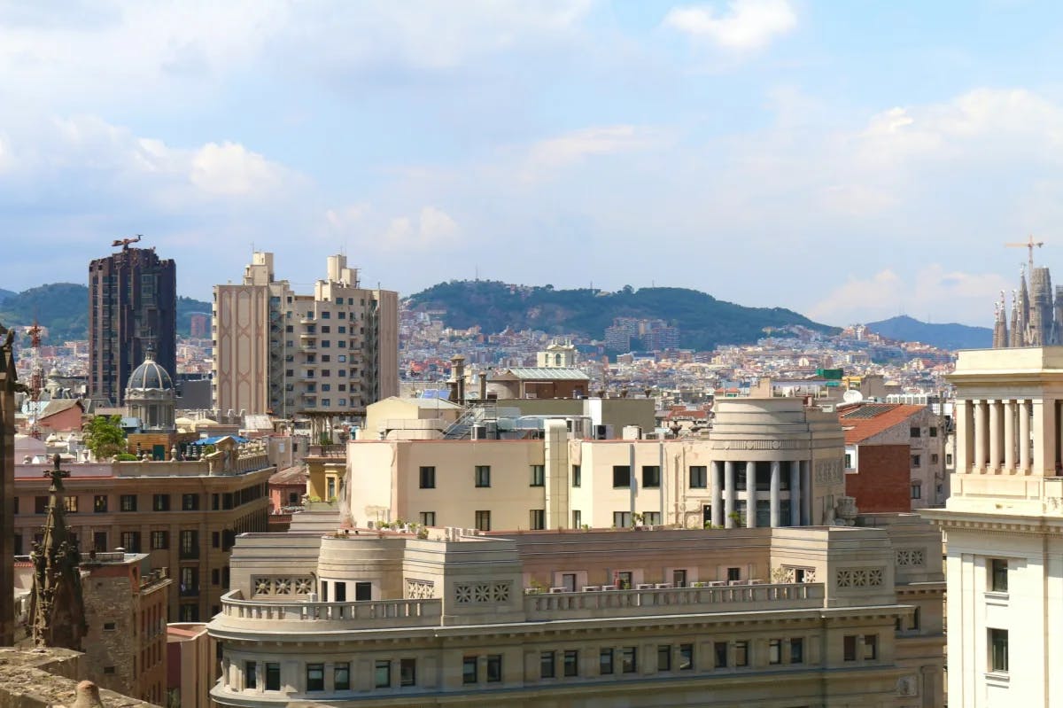 City view with buildings and mountains.