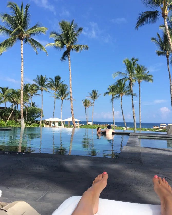 Advisor relaxing at a pool during the day.