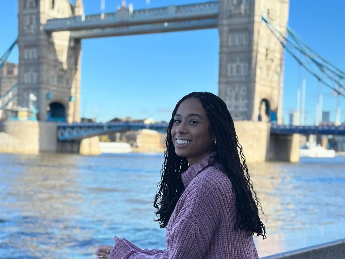 Girl wearing pink sweater on a towerbridge