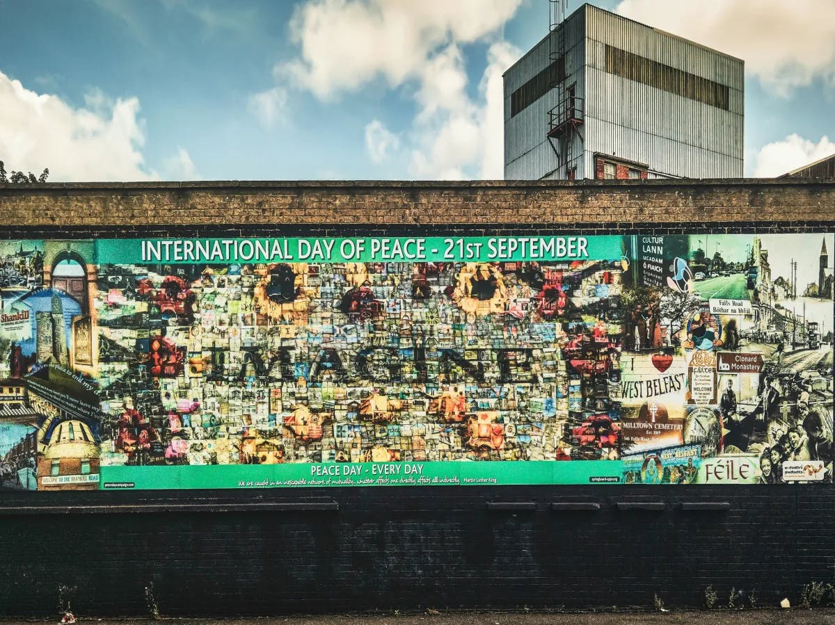 A colorful mural celebrating the International Day of Peace with the word “IMAGINE” prominently displayed.