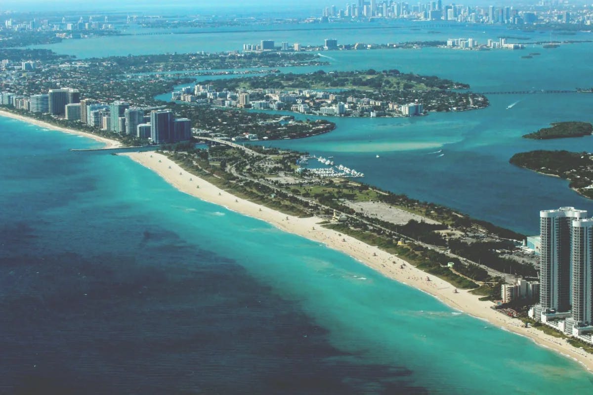 Overview of beachfront city with buildings and beach.