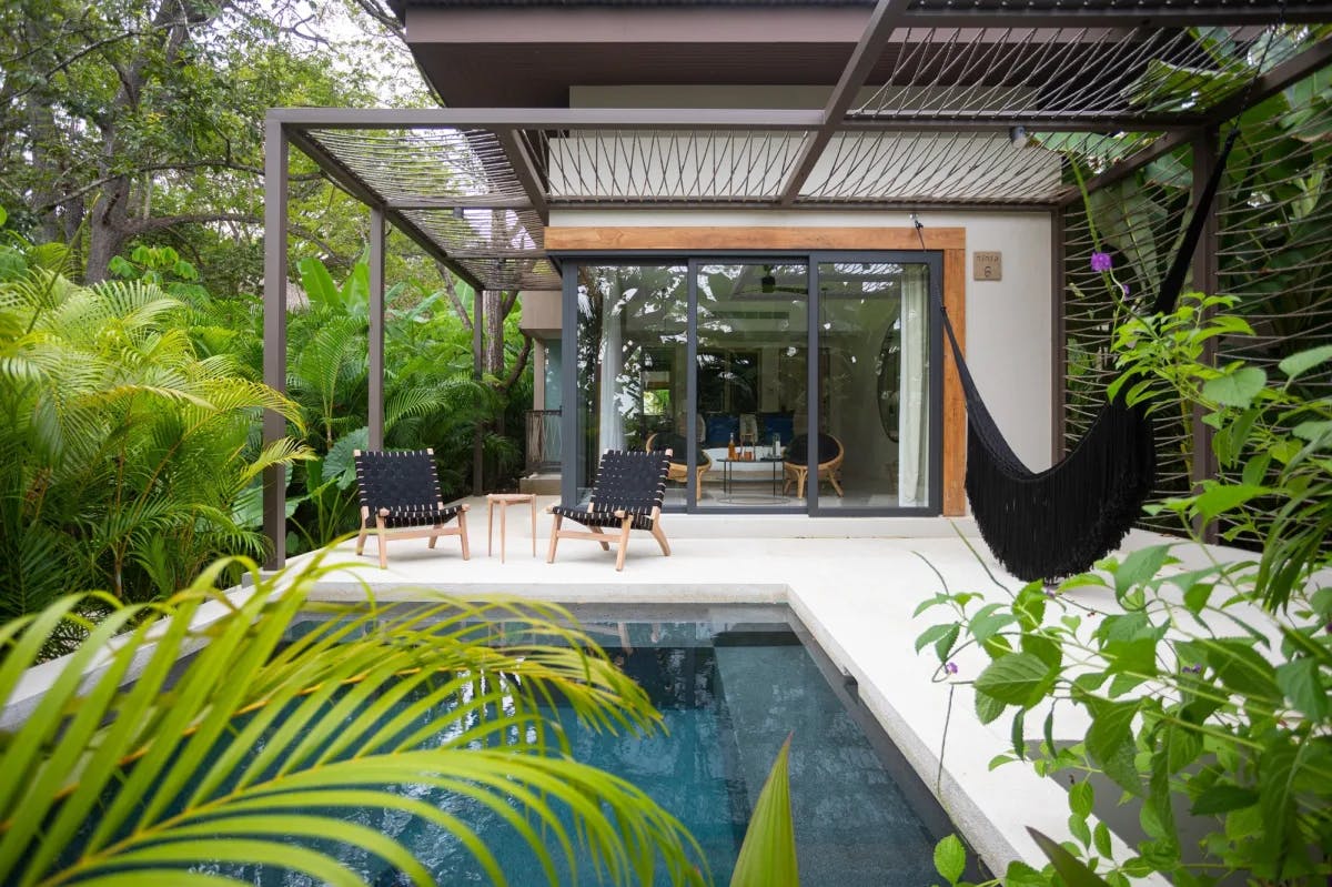 a luxe jungle villa with a private plunge pool and a black hammock