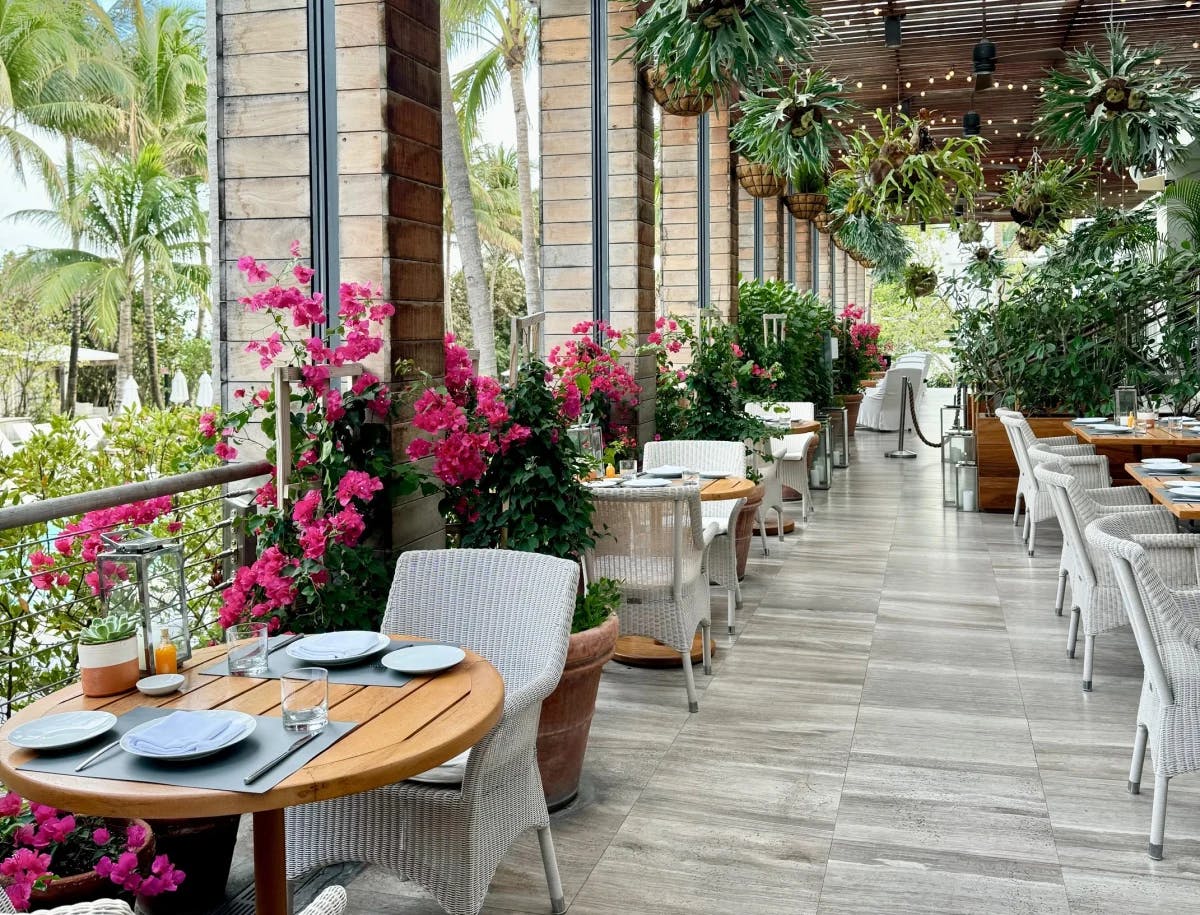 A restaurant with flowers in the balcony