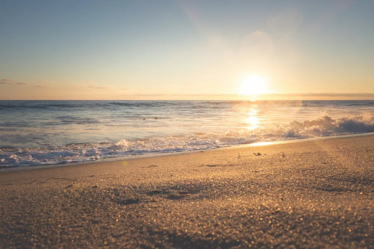 An aerial view of the beach during the sunrise.