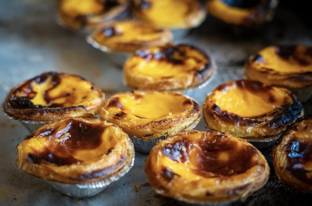 A photo of golden browned muffin-shaped food native to Portugal.