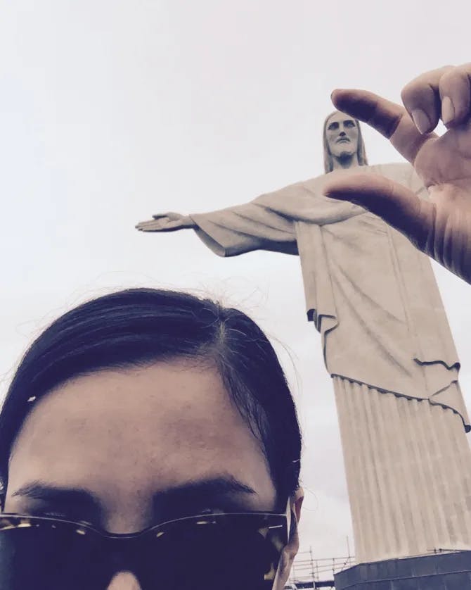 A selfie of Lynette next to the Christ the Redeemer sculpture