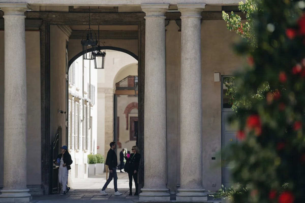 Stone pillars over an entrance to a hotel in Milan