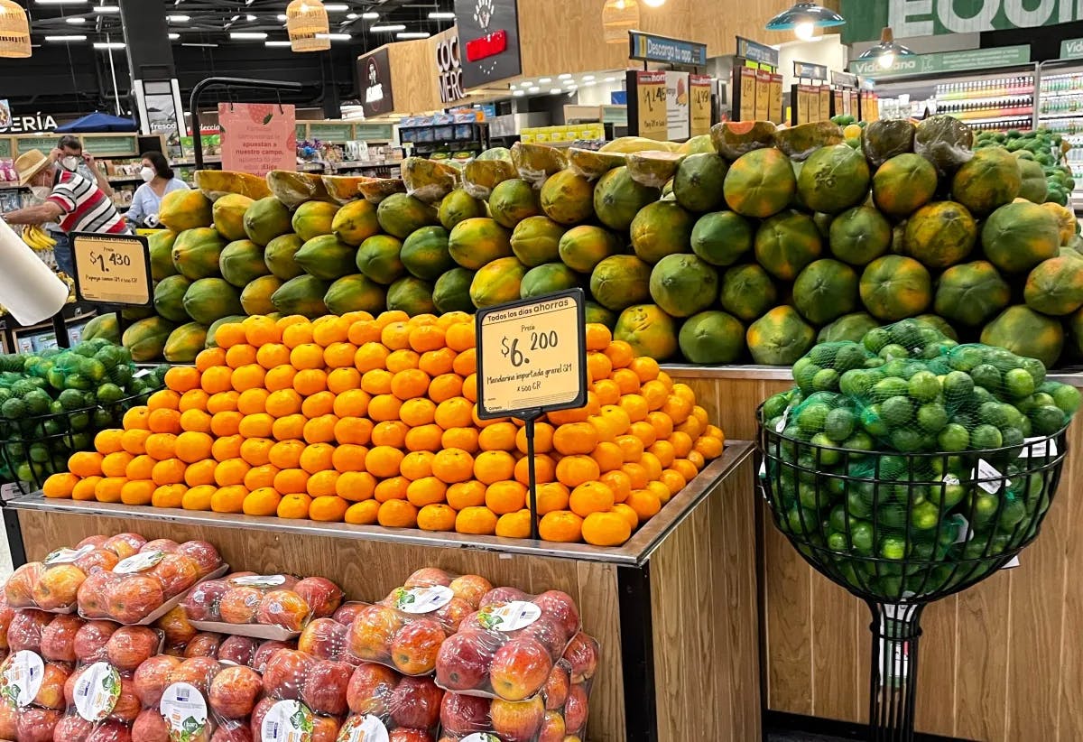 A colorful array of fresh fruits on display, showcasing the variety and orderliness of a supermarket’s produce section.