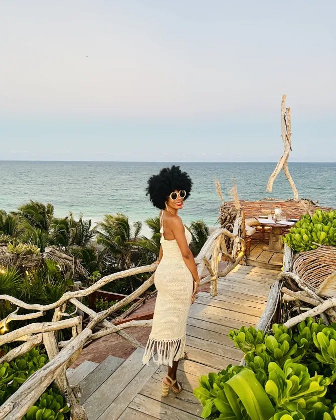 Travel advisor wearing white dress standing on the seaside