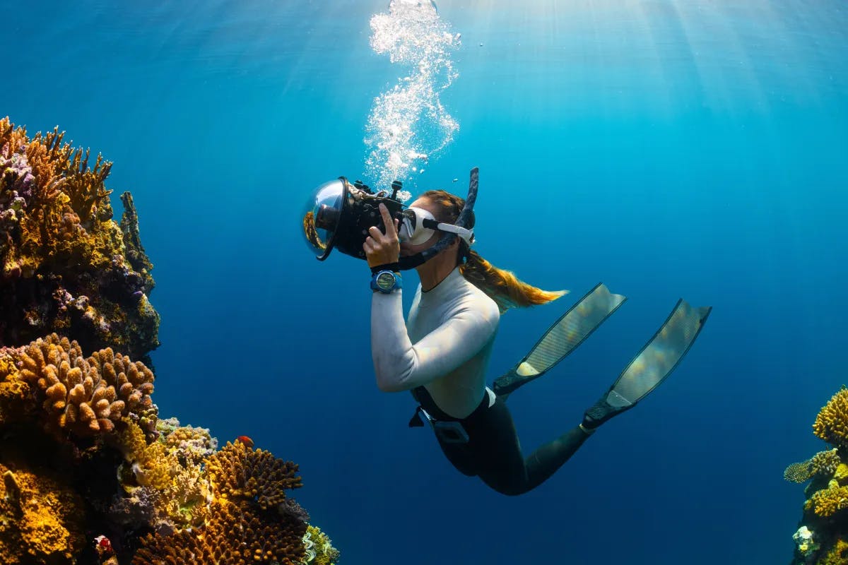 A girl under water doing snorkeling adventure.