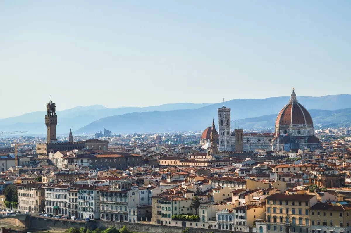 Aerial view of Florence with mountains fading in the distance. 
