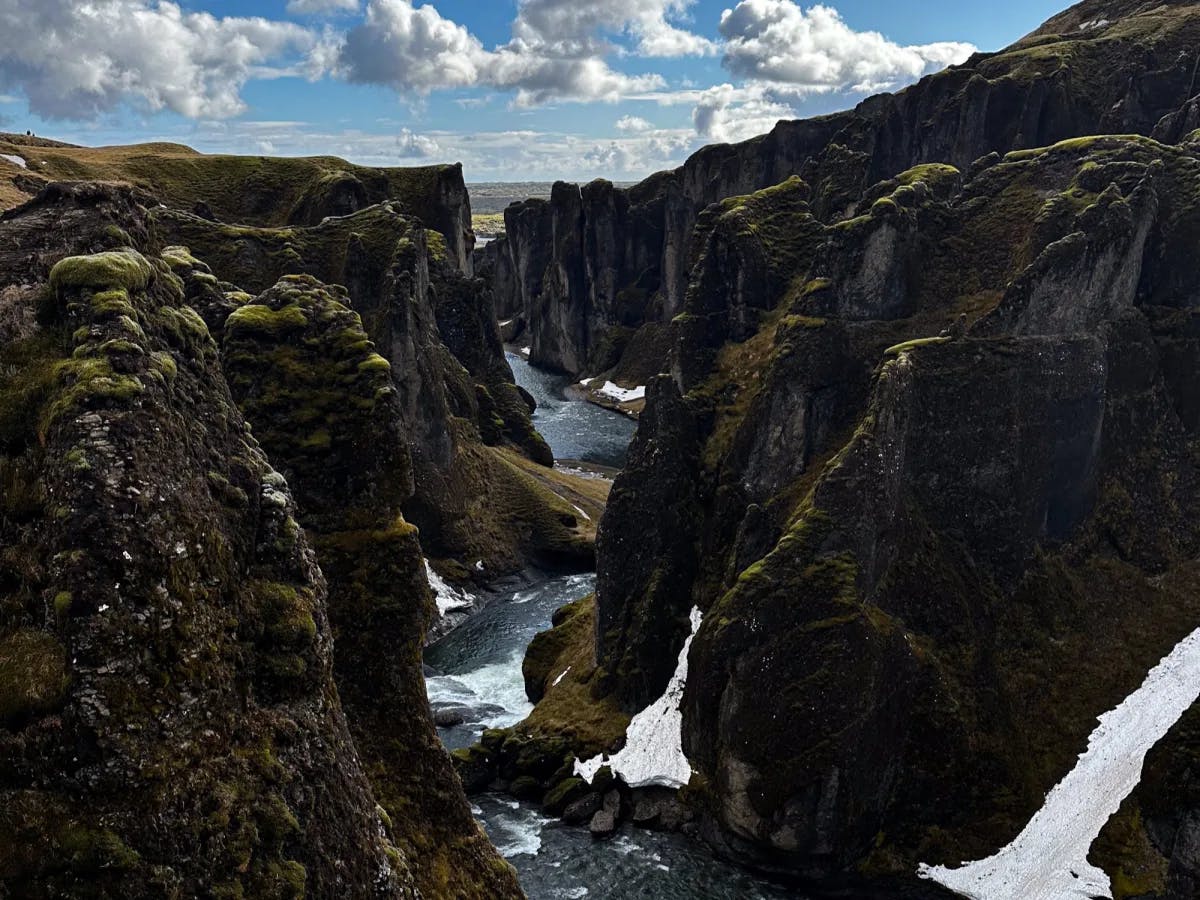 Fjadrargliufur Gorge with a river between tall rocky outcroppings.