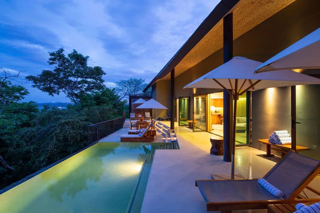 All-inclusive villa with private pool and sun beds after sunset in Andaz Costa Rica.