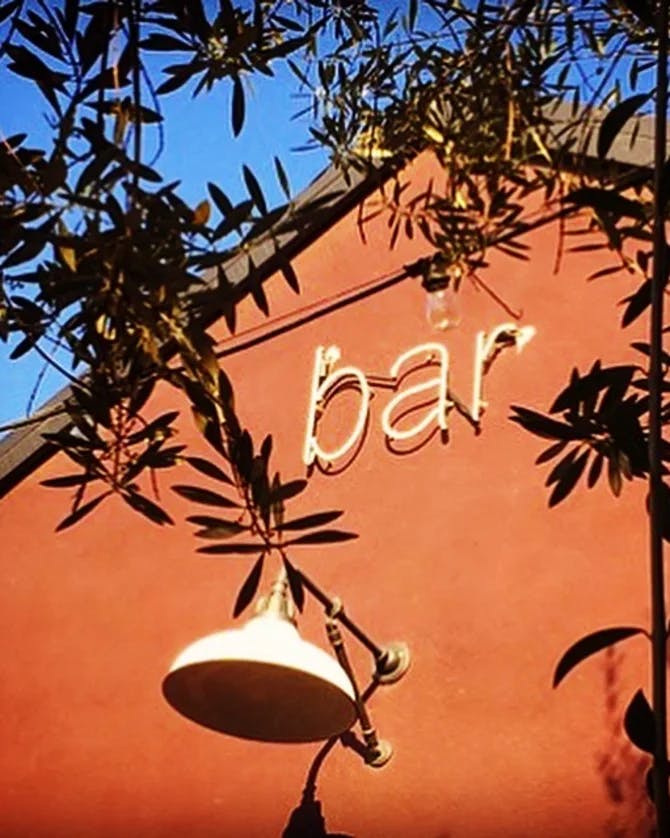 A brick wall with "bar" written on it