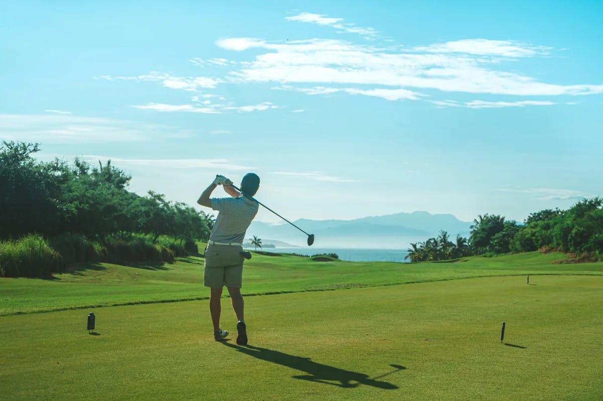 A man playing golf on a golf course. 