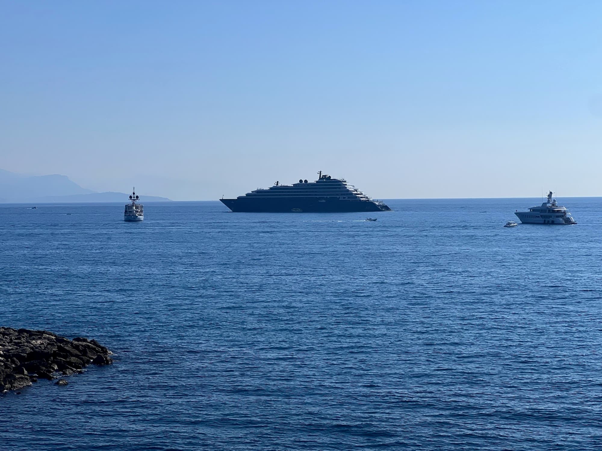 View of the cruise ship in Italy drifting toward the shore on a clear day. 