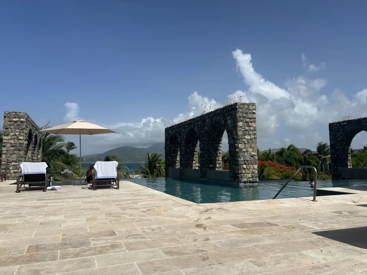 Park Hyatt pool overlooking the ocean views on a sunny day with wisps of clouds.  